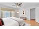 Bright main bedroom boasting hardwood floors, a ceiling fan, and neutral paint at 2702 Moorings Pkwy, Snellville, GA 30039