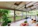 Large, covered patio with views of the beautifully landscaped backyard and comfortable seating area at 2702 Moorings Pkwy, Snellville, GA 30039