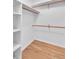 Bright walk-in closet with built-in shelves and hardwood floors for maximum storage at 2702 Moorings Pkwy, Snellville, GA 30039