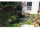 Backyard pond with rocks and shrubbery creating a tranquil escape at 329 Kyles Cir, Hiram, GA 30141