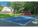 Backyard basketball court with a net, basketball, storage building, and green surroundings at 329 Kyles Cir, Hiram, GA 30141
