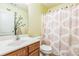 Charming bathroom with a wood vanity, patterned shower curtain, and a decorative tree wall decal at 329 Kyles Cir, Hiram, GA 30141