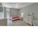 Bright bedroom featuring a ceiling fan, and a white dresser and bed frame at 329 Kyles Cir, Hiram, GA 30141