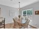 Cozy dining room with a wooden table, six chairs, a large window, and tiled floors at 329 Kyles Cir, Hiram, GA 30141