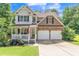 Charming two-story home with a well-maintained lawn, stone accents, and a welcoming front porch at 329 Kyles Cir, Hiram, GA 30141