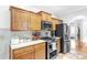 Bright kitchen with wood cabinets, stainless steel appliances, granite counters, and a view into the dining area at 329 Kyles Cir, Hiram, GA 30141