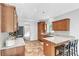 Well-lit kitchen with wooden cabinetry, granite countertops, stainless steel appliances, and tiled flooring at 329 Kyles Cir, Hiram, GA 30141
