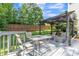 Pergola with outdoor seating perfect for entertaining, with a view of the fenced-in backyard at 329 Kyles Cir, Hiram, GA 30141