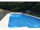 Backyard in-ground pool with fence, safety cover, and ladder at 329 Kyles Cir, Hiram, GA 30141