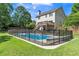 Backyard pool surrounded by a safety fence, deck, and green grass at 329 Kyles Cir, Hiram, GA 30141