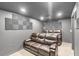 Theater room with brown leather sofas and soundproofing panels at 329 Kyles Cir, Hiram, GA 30141