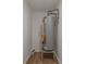 Small utility closet containing a hot water tank and basic fixtures at 510 Northridge Crossing Dr, Sandy Springs, GA 30350