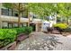 Lovely entryway with paved surface, manicured bushes, benches, and access to units on multiple levels at 1850 Cotillion Dr # 4419, Atlanta, GA 30338