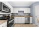 Nicely appointed kitchen featuring granite countertops, stainless appliances, and white cabinetry at 1850 Cotillion Dr # 4419, Atlanta, GA 30338