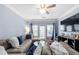 Comfortable living room with ceiling fan, blue accent wall, and plush sectional sofa at 1850 Cotillion Dr # 4419, Atlanta, GA 30338