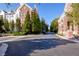 Street view showcases an upscale condo complex with mature landscaping, and classic brick architecture at 1850 Cotillion Dr # 4419, Atlanta, GA 30338
