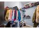 Organized walk-in closet with clothes, shoes, and storage shelves at 1850 Cotillion Dr # 4419, Atlanta, GA 30338