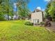 Expansive backyard with a lush lawn, deck, and charming landscaping, creating a private retreat at 2956 Springlake Dr, Buford, GA 30519