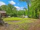 Spacious backyard with lush greenery and an inviting fire pit area for outdoor gatherings at 2956 Springlake Dr, Buford, GA 30519