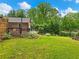 Beautifully landscaped backyard with a wooden deck and mature trees, ideal for outdoor living at 2956 Springlake Dr, Buford, GA 30519