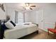 Relaxing bedroom with a metal frame bed, accent chair, and a bright window at 2956 Springlake Dr, Buford, GA 30519