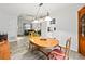 Light-filled dining area with wood furnishings, a decorative light fixture, and an adjacent living area at 2956 Springlake Dr, Buford, GA 30519
