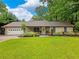 Charming single-story home with a lush green lawn and mature trees providing ample shade at 2956 Springlake Dr, Buford, GA 30519