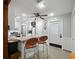Bright kitchen featuring a breakfast bar with seating, white cabinetry, and modern appliances at 2956 Springlake Dr, Buford, GA 30519