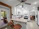 Open kitchen with breakfast bar, white cabinets, stainless appliances, and outdoor access at 2956 Springlake Dr, Buford, GA 30519