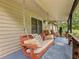 Relax on this charming porch swing with decorative pillows on the covered front porch at 2956 Springlake Dr, Buford, GA 30519