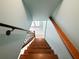 Wooden staircase leading to the tiled foyer and sunlit entryway at 2956 Springlake Dr, Buford, GA 30519