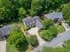 Expansive aerial view of a house nestled among lush green trees in a quiet neighborhood with ample yard space at 4070 Ridgehurst Se Dr, Smyrna, GA 30080