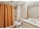 Cozy bathroom featuring a shower/tub combo with a neutral shower curtain, toilet and a single sink vanity with mirror at 4070 Ridgehurst Se Dr, Smyrna, GA 30080