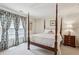 Bedroom featuring a four poster bed, side table and blue floral drapes at 4070 Ridgehurst Se Dr, Smyrna, GA 30080