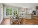 Bright eat-in kitchen features a glass-top table, wood floors, and a beautiful backyard view at 4070 Ridgehurst Se Dr, Smyrna, GA 30080