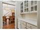 Butler's pantry with tile countertops, built-in cabinets, and views into the dining room at 4070 Ridgehurst Se Dr, Smyrna, GA 30080