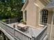Large deck features a wooden railing and dining set, the perfect setting for outdoor meals and enjoying the neighborhood at 4070 Ridgehurst Se Dr, Smyrna, GA 30080