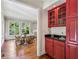 Cozy dining area featuring red cabinetry with a sink and a view into a bright breakfast nook at 4070 Ridgehurst Se Dr, Smyrna, GA 30080