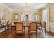 Formal dining room with hardwood floors, wainscoting, floral wallpaper, and a chandelier at 4070 Ridgehurst Se Dr, Smyrna, GA 30080