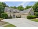 Charming home featuring a spacious driveway, manicured lawn, and a symmetrical facade at 4070 Ridgehurst Se Dr, Smyrna, GA 30080