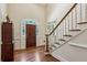 Foyer with wood floors, high ceilings, paneled walls, and sidelights flanking the wood door at 4070 Ridgehurst Se Dr, Smyrna, GA 30080