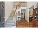 Bright foyer features a staircase with wood railing and an open floor plan to the dining room at 4070 Ridgehurst Se Dr, Smyrna, GA 30080