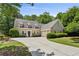 Charming home with a well-manicured lawn, beautiful shrubs, and a long driveway leading to a two-car garage at 4070 Ridgehurst Se Dr, Smyrna, GA 30080