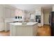 Bright eat-in kitchen boasts modern white cabinetry, an island, and stainless steel appliances at 4070 Ridgehurst Se Dr, Smyrna, GA 30080