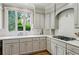 The kitchen features white cabinets, countertops and backsplash and a window view at 4070 Ridgehurst Se Dr, Smyrna, GA 30080
