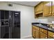 Wet bar with a stainless sink, dark countertops, and rich wood cabinets; ready for entertaining or just keeping your snacks handy at 4070 Ridgehurst Se Dr, Smyrna, GA 30080
