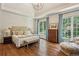Serene main bedroom with hardwood floors, vaulted ceiling, and large windows with lush views at 4070 Ridgehurst Se Dr, Smyrna, GA 30080