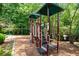 Community playground with swings and a play structure, nestled in a wooded area, making it the perfect place to play at 4070 Ridgehurst Se Dr, Smyrna, GA 30080