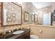 Charming powder room with ornate wallpaper and a decorative mirror over a vanity at 4070 Ridgehurst Se Dr, Smyrna, GA 30080