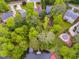 Aerial view of a home with a pool, dock, and beautiful surrounding trees at 5200 Woodmont Dr, Villa Rica, GA 30180